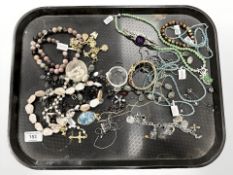 A group of costume jewellery, beaded necklaces, pendant on chain, wristwatches, rosary beads.