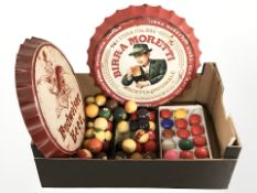 Two Birra Moretti and Budweiser advertising bottle cap plaques, and a quantity of billiard balls.