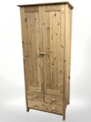 A modern pine double door wardrobe, 75 cm W x 53 cm D x 180 cm H.