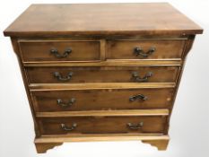 A reproduction yew wood five drawer chest, 75 cm x 43 cm x 73 cm.