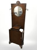 A 1920s oak mirrorback hall stand, width 62 cm.