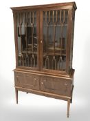A reproduction continental stained teak double door cabinet, 110 cm W x 47 cm D x 180 cm H.