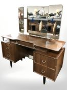 A 20th century G Plan teak and ebonised five drawer dressing table designed by E.