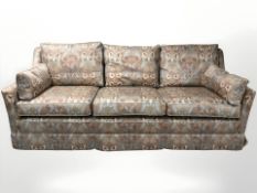A 20th century three piece lounge suite in floral upholstery.