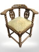An early 20th century oak bobbin turned corner armchair
