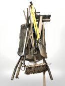 A wheel barrow containing garden tools