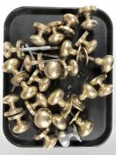 A group of mainly brass door knobs.