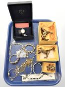 A group of costume jewellery, ornate figures, bracelets,