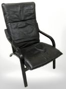 A Danish Stouby black leather upholstered lounge armchair, width 63 cm.