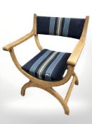 A Danish blonde oak X-frame open armchair,
