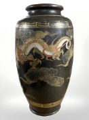 An early 20th century Japanese earthenware vase depicting a dragon, height 32 cm.