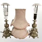 A pair of ornate gilt brass lamp bases, with shades, height 47 cm.