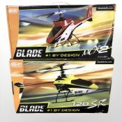 Two Blade remote control helicopters in boxes.