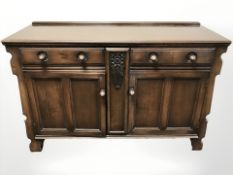 An early 20th century oak sideboard, 138 cm W x 52 cm D x 91 cm H.
