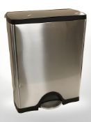 A stainless steel pedal bin,