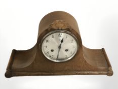 A Junghans carved oak mantel clock, width 47 cm, with pendulum and key.