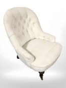 An early 20th century lady's chair in buttoned upholstery