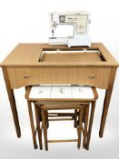 Singer 438 electric sewing machine in table and a nest of three tiled inset tables