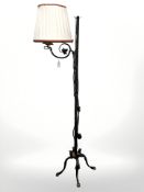 A wrought metal standard lamp