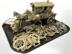 A collection of horse brasses, caravan, horse and cart, dog, and a small timepiece.