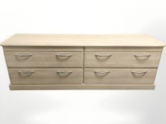 A contemporary four drawer laminated chest, 180 cm L x 46 cm D x 61 cm H.
