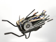 A wheel barrow of assorted garden tools and an extension reel
