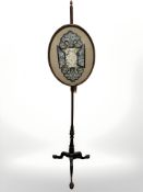 A mahogany tripod pole screen on claw and ball feet,