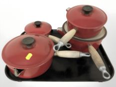 A group of Le Creuset enameled cast iron saucepans, with lids.