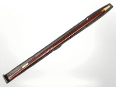 A military rosewood and brass pace stick with cover.