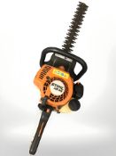 A Stihl petrol hedge trimmer.