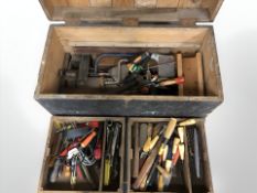 An antique joiner's toolbox containing assorted carpentry tools.