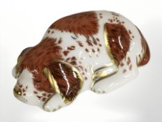 A Royal Crown Derby puppy paperweight with gold stopper.
