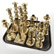 A quantity of brass candlesticks, antique and later examples, including some pairs.