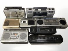 A group of vintage radios including Sanyo, Philips, Sony, etc.