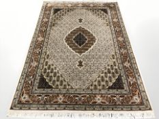 A Tabriz rug, 250 cm x 163 cm.