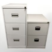 Two metal filing cabinets with keys,