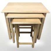 A nest of three contemporary oak veneered tables, width 68 cm.