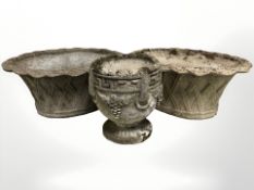 A pair of weathered concrete woven basket planters,