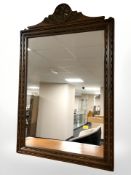 A reproduction carved oak mirror,