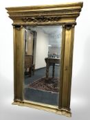 A reproduction Regency style gilt mirror, 107 cm W x 16 cm D x 152 cm H.