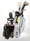 A golf bag containing assorted irons and drivers including Matrix and two golf bag caddies