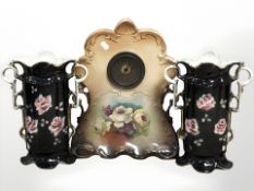 A transfer printed pottery mantel clock, height 40 cm, and pair of twin handled vases.