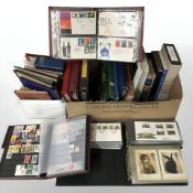 A collection of albums containing stamps and first day covers.