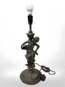 A patinated metal figural table lamp, in the form of a lady,