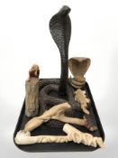 A group of wooden ornaments of snakes and lizards.