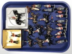 A group of painted die cast soldiers, guardsman, cavalry figures,