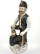 A ceramic figure of a pit miner,