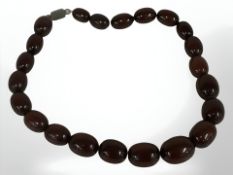 A cherry amber/Bakelite bead necklace with silver clasp