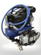 A Draper compressor and a further vacuum pump