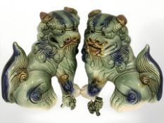 A pair of Chinese pottery temple dog figures, height 21 cm, and two smaller examples.